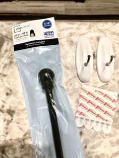 a pair of white slippers sitting on top of a counter next to a black handle