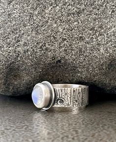 Size 8 Sterling silver ring featuring a round Moonstone cabochon with hand stamped tree bark inspired band and oxidized satin finish. Moonstone cabochon measures approximately 9mm/5mm. Sterling band measures approximately 8mm/1.75mm.  I hand fabricate my work from solid Sterling Silver using traditional metalsmith tools and techniques. Ready to Ship! All items gift boxed. The design was inspired by the unique textured driftwood logs on the beach for my collection of modern contemporary ocean ins Ocean Inspired Jewelry, Moonstone Cabochon, Tanzanite Ring, Rainbow Moonstone Ring, Ocean Inspired, Tree Bark, Inspired Jewelry, Ocean Inspiration, Moonstone Ring