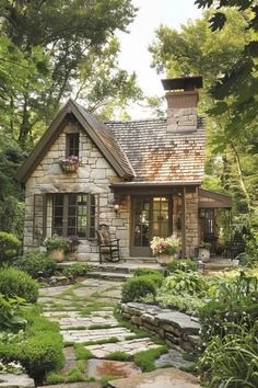 a small stone house surrounded by greenery and trees