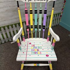 a chair made out of crayon sticks with writing on the back and sides