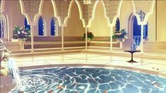 an artistic rendering of a fountain in the middle of a room with arches and windows