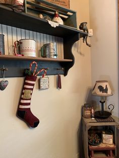 a christmas stocking hanging on the wall next to a shelf filled with other items