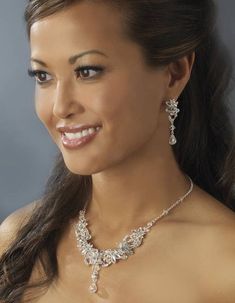 a beautiful woman wearing a necklace and earrings