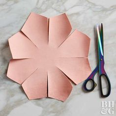 the paper flower is cut out and ready to be sewn into it's shape