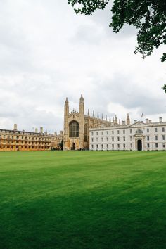 a large building with a clock tower in the middle of it's front yard