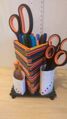 a stack of scissors and pencils sitting on top of each other