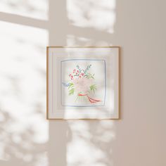 a painting hanging on the wall in front of a window with sunlight coming through it