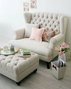 a white chair and ottoman in a room