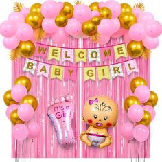 a baby shower with balloons and streamers on the wall, including a welcome baby girl sign