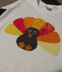 a close up of a turkey applique on a white shirt