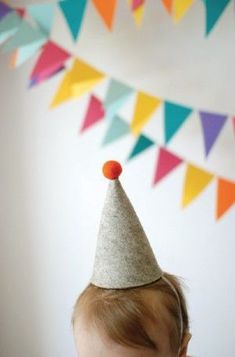 a baby with a party hat on his head