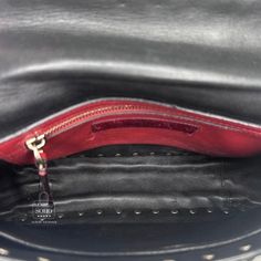 Pre-owned Valentino Bag Black Leather Printed VLTN Rock stud accents Pale Gold-Tone Hardware Flat Handle & Removable Chain-Link Strap Red/Black Leather Lining & Dual Interior Pockets Turn-Lock Closure at Front Guaranteed authentic. Condition: 8.5/10 Very good. Light signs of use to interior. Indentations to inside flap from hardware. Scratches to the white Letter “T” Details: Shoulder Strap Length: 22.25" Handle Drop: 3" Height: 6.5" Width: 9.75" Depth: 3 Luxury Shoulder Bag With Rivets, Luxury Evening Shoulder Bag With Rivets, Designer Formal Bags With Studs, Formal Black Shoulder Bag With Studs, Designer Leather Shoulder Bag With Studs, Designer Evening Bags With Rivets, Designer Black Bag With Studs, Designer Black Bags With Studs, Black Designer Bag With Rivets