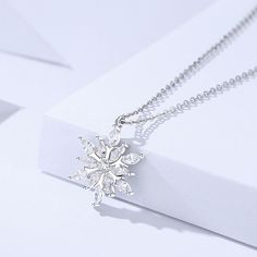 Description & Details Embrace the enchanting beauty of winter with our intricately crafted pieces inspired by the delicate and unique snowflakes. Each design in our collection captures the mesmerizing allure and symbolism associated with these crystalline wonders. • Material: Solid 925 Sterling Silver ∙ Cubic Zirconia• Finish: Hypoallergenic ∙ Gold Plating• Dimensions: 14 x 16 mm pendant, 40 - 45 cm chain, adjustable• All our work is custom made by hand with love Elegant Winter Jewelry As Gift, Fine Jewelry Snowflake Gift, Christmas Silver Cubic Zirconia Necklace, Silver Cubic Zirconia Necklaces For Christmas, Elegant Snowflake Shaped Cubic Zirconia Jewelry, Snowflake Shaped Sparkling Sterling Silver Jewelry, Sparkling Snowflake Jewelry In Sterling Silver, Sparkling Snowflake Sterling Silver Jewelry, Winter White Sterling Silver Necklaces