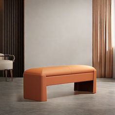 an orange bench sitting in the middle of a room