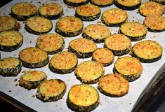 some food is laying out on a baking sheet and ready to be cooked in the oven