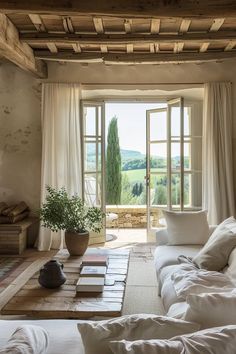 a living room filled with lots of white furniture and pillows on top of a wooden table