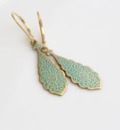 "These casual little earrings are perfect for every day. They are brass/gold with a greenish turquoise patina finish. The pair dangle from 14k gold filled ear wire that comes in two different styles... lever back or ball & hook. (pictured above) The earrings dangle at a total of 45mm (1 3/4\"). If you have any questions please do not hesitate to contact me. ALSO AVAILABLE IN SILVER... https://www.etsy.com/listing/214313768/dangling-silver-earrings-sterling-silver?ref=shop_home_active_15 GOLD Elegant Turquoise Teardrop Pierced Earrings, Elegant Turquoise Brass Jewelry, Turquoise Teardrop Brass Jewelry, Turquoise Filigree Earrings For Gift, Turquoise Filigree Earrings As Gift, Turquoise Jewelry With Ear Wire For Wedding, Turquoise Wedding Jewelry With Ear Wire, Gold Teardrop Earrings, Turquoise And Gold