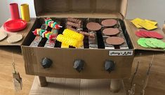 an open cardboard box filled with different types of cookies and pastries on top of a wooden table