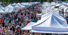 a large group of people standing around tents