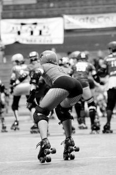 a group of people riding skateboards on top of a field