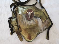 High quality small Leather bag A combination of gold  leather And synthetic fur One small compartment inside Handmade Decorated with bull pendant Handmade Gold Shoulder Bag For Festival, Handmade Gold Bags For Festivals, Gold Bohemian Shoulder Bag For Festivals, Handmade Leather Festival Bag, Handmade Bohemian Gold Shoulder Bag, Mountain Man Possibles Bag, Viking Leather Bag, Festival Girls, Small Leather Bag