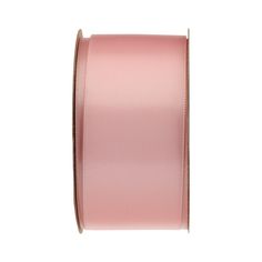 a roll of pink satin ribbon on a white background