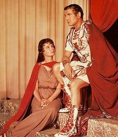 the man and woman are dressed in roman costumes