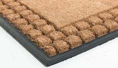 a brown and black area rug on top of a white floor with no one in it