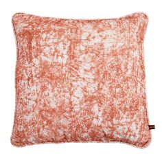 an orange and white pillow on a white background