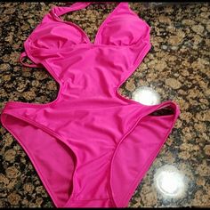 Sexy Cutout Swimsuit. Halter Neck Ties And Spaghetti Back Ties. Bikini Back Look. Insert Lining Cups. Beautiful Hot Pink This Suit Is Brand New From Boutique Collections However Has No Tags. Never Worn. Fits Like A Medium. Party One-piece Swimwear With Built-in Bra, Pink Backless Party Swimwear, Triangle Top Bodysuit For Club With Lined Body, Triangle Top Lined Bodysuit For Club, Triangle Top Bodysuit With Lined Body For Club, Fitted Triangle Top Bodysuit For Night Out, Pink Sleeveless Party One-piece, Summer Club Bodysuit In Flirty Style, Summer T-back Bodysuit For Club