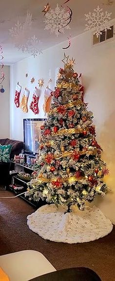 a living room with a christmas tree in the corner