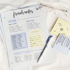 a notepad, pen and glasses on top of a sheet of paper