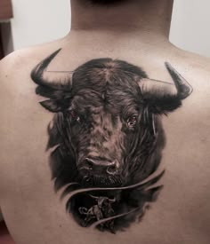 a man with a bull tattoo on his back