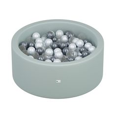 a bowl filled with black and white balls