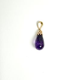 This beautiful amethyst briolette pendant is a stunning piece that captures the essence of elegance and sophistication. The pendant features a mesmerizing amethyst briolette, delicately adorned with a 14 karat yellow gold cap boasting an intricate openwork design. The combination of the captivating purple hues of the amethyst and the luxurious yellow gold creates a harmonious blend of beauty and style. Indulge yourself or surprise a loved one with this exquisite pendant. and let the timeless bea Elegant Purple Teardrop Gemstone, Luxury Purple Drop Jewelry, Faceted Amethyst Briolette Gemstones, Luxury Teardrop Amethyst Jewelry, Pendant Designs, Gold Cap, Gold Caps, Enamel Ring, Amethyst Pendant