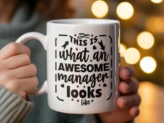 a person holding a coffee mug with the words, this is what an awesome manager looks like