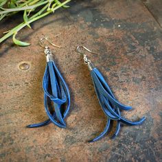 "-These tassel earrings are made from soft cadet-blue deerskin leather. Part Western, part Boho, part Rock 'n Roll, these little fringe earrings give a big kick to any outfit. -Lightweight enough to wear every day. -3\" - 3.5\" total length, including earwires. -Earwires are silver-color. -Deerskin leather is sustainably sourced in the USA. -Ok to get wet. -Available in 13 colors. -Designed and handmade in South Pasadena, CA. Check out more of our awesome earrings here: https://www.etsy.com/shop Handmade Blue Leather Earrings, Blue Bohemian Leather Earrings, Blue Leather Bohemian Earrings, Bohemian Blue Leather Earrings, Bullet Shell Jewelry, Leather Tassel Earrings, Awesome Earrings, Black Statement Earrings, Repurposed Necklace