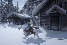 a man riding on the back of a white horse in front of a log cabin