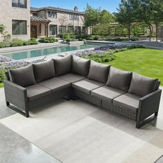 an outdoor sectional sofa with grey cushions