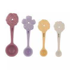 three different colored spoons with flower shaped handles