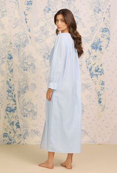 Our best selling Dobby Stripe Collection is now available with a coordinating button front robe. This can be worn alone as a nightie or as a robe to make a perfect set with the Dobby Stripe Ballet Gown. A clean and classic look, this 100% cotton robe is designed with a delicate dobby stripe, accented by venise lace at the neckline, pintucks at the neckline and skirt, and a full button front of shimmery akoya buttons. The Robe is 52" inches long and has ruffle elastic sleeves and side seam pocket Relaxed Fit Cotton Nightgown For Casual Wear, Cotton Nightgown With Relaxed Fit For Daywear, Blue Long Sleeve Dress For Pajama Party, Blue Cotton Sleepwear With Buttons, Blue Long-sleeve Sleepwear With Buttons, Cotton Chemise For Bedtime, Blue Long Sleeve Sleepwear With Buttons, Long Sleeve Blue Nightgown For Home, Spring Cotton Chemise For Bedtime