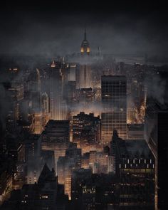 an aerial view of the city at night with fog and smoggy skies in the background