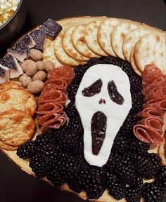 a halloween platter with crackers, crackers and cheeses in the shape of a ghost