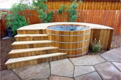 an outdoor hot tub with steps leading up to it