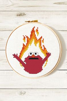 a cross stitch pattern with an image of a cartoon character on fire