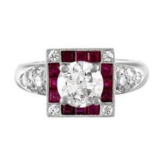 a diamond and ruby ring with diamonds on the sides, set in white gold or silver