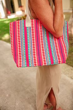 Elevate your style with our Enjoy The View Tote Bag! This stunning tote features a unique and eye-catching pattern that is sure to turn heads. Perfect for carrying all your essentials while making a chic statement. Order now and enjoy the view in style! Limited quantities available, secure your bag today! Every bag is unique and colors may vary. -100% Viscose -Spot Clean -Shoulder Straps -Measurements: L 14" W19" H 3.4" Trendy Large Capacity Red Beach Bag, Trendy Red Beach Bag With Large Capacity, Trendy Beach Bag With Top Carry Handle For Vacation, Multicolor Canvas Shoulder Bag For Vacation, Multicolor Shoulder Canvas Bag For Vacation, Trendy Red Beach Bag, Multicolor Tote Canvas Bag For Vacation, Multicolor Tote Bag For Vacation, Multicolor Canvas Tote Bag For Vacation