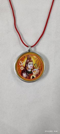 Handmade 92.5 Sterling Silver God Om Namah Shivay Shiva Religious Photo Print Glass Framed Silver Photo Unique Pendant With Colour String. Made by My Shop Members. Primary Colour Is Silver  Pendant Length With Loop 3.8 Cm. Pendant Width 3.2 Cm. Pendant Weight 4.5 gms.  Few Golden Colour Hand Work On Photo Print ,Not Total Hand Painted. Handmade Glass Framed Necklace Covered By 92.5 Sterling Silver. It's a not totally water proof, but water resistant glass framed Pendant.  Special... It's Possible to Make as Customers Choice like Couple /Be loved / Pet / Ideal/Someone special Every Type of Print. Your Feedback is very Important for us so leave positive Feedback. If you have any Problem or you are not satisfied with our product so Please Contact us before leaving negative Feedback. We also B Red Round Necklace For Puja, Handmade Orange Jewelry For Puja, Nickel-free Necklaces For Festivals, Adjustable Pendant Necklace For Puja, Religious Photos, Om Namah Shivay, Photo Pendant, Beautiful Gift Wrapping, Unique Necklace