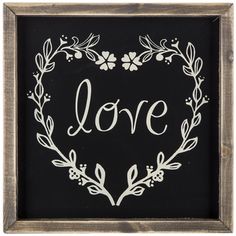 a chalkboard with the word love written on it in a heart shape surrounded by leaves and flowers