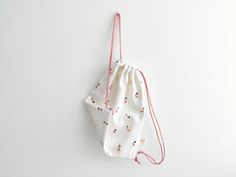 a drawstring bag hanging on the wall